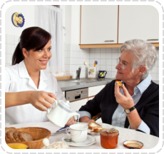 a personal caretaker helping her patient eating meal